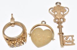 Three 9ct gold charms in the form of a key, a wedding band and engagement ring and a swivel 'I