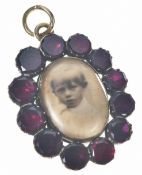 A c1850 Victorian pendant / locket set with foiled garnets, verso a locket compartment, 4.7g, 2.8