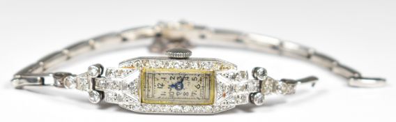 Art Deco platinum ladies wristwatch set with blued hands, silver dial and diamond set case, on