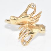 A 14k gold ring in the form of two hands set with diamonds, 2.3g, size M