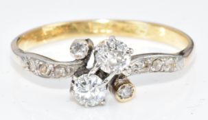 An 18ct gold ring set with diamonds in a twisted platinum setting, the total diamond weight