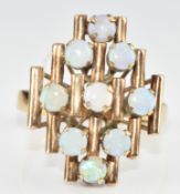 A 14k gold ring set with nine round cut opal cabochons, 4.1g, size T