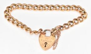 A 9ct rose gold curb link bracelet with heart padlock clasp, 11.2g, 18cm