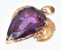 A 14k gold pendant set with a pear cut synthetic sapphire, 13.5g, 4cm