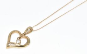 A 9ct gold heart pendant set with cubic zirconia, on chain, 1.3g, 42cm