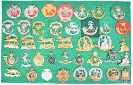 Thirty nine cap badges and insignia including 1st Volunteer Battalion Cornwall, Cornwall Light