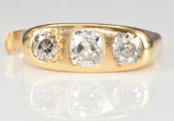 An 18ct gold ring set with three old cut diamonds of approximately 0.82ct, 0.6ct and 0.5ct, 10.3g (