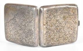 George V hallmarked silver cigarette case of curved design with engraved decoration and gilt