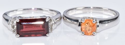 Two 9k white gold rings, one set with a garnet and topaz and the other a garnet, with certificate,