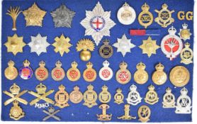 Approximately 45 cap badges, shoulder titles and insignia including Coldstream Guards, Household