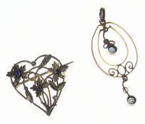 A 9ct gold brooch in the form of flowers set with sapphires (one missing, 2.4cm) and an Edwardian