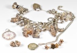 Silver charm bracelet with twelve charms including camera, horse's head, dogs, etc, silver St