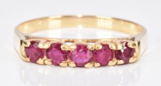 A 9ct gold ring set with five round cut rubies, 2g, size O
