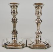 Pair of Victorian hallmarked silver candlesticks with knopped stems and square bases with incuse