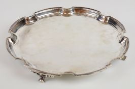Elizabeth II hallmarked silver salver with shaped edge, raised on four feet, London 1961, maker's