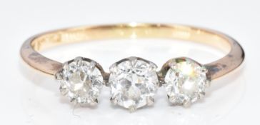 An 18ct gold ring set with three round cut diamonds of approximately 0.3ct, 0.2ct & 0.2ct, 2.2g,