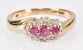 A 9ct gold ring set with three rubies surrounded by diamonds, 2.8g, size N