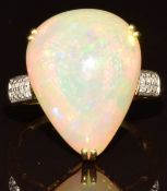 An 18k gold ring set with a pear cut Ethiopian opal cabochon of approximately 7.4ct and sixteen