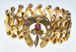 A c1900 15ct gold expandable bracelet with horseshoe and shamrock decoration set with split pearls