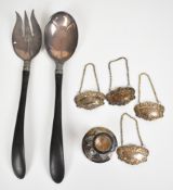 Eastern silver candlestick, four silver plated bottle tickets and a pair of American salad servers