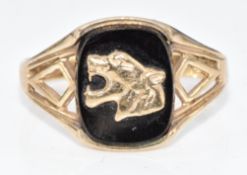 A 9ct gold signet ring set with onyx with leopard head decoration, 3.2g, size S