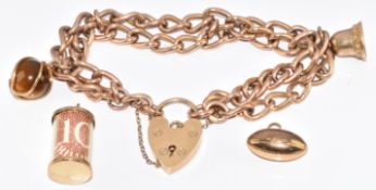 A 9ct rose gold charm bracelet made from an Albert / watch chain with four 9ct gold charms including
