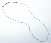 A single strand of seed pearls with white gold clasp set with diamonds (one diamond missing), 5.