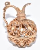 A 9ct gold charm in the form of a jug in filigree, 6.1g, 2.5cm