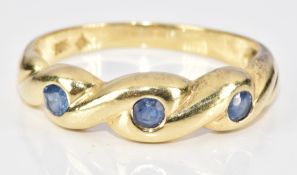 A 14k gold ring set with three round cut sapphires, 3.5g, size P