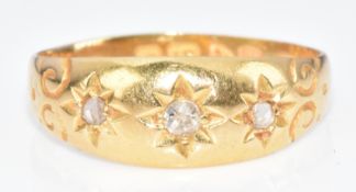 An 18ct gold ring set with three diamonds in star settings, Chester 1911, 2.1g, size I