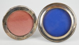 Two circular hallmarked silver photograph frames, one Birmingham 1989, maker W I Broadway & Co, with