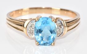 A 9ct gold ring set with an oval cut blue topaz and diamonds, 2.4g, size R