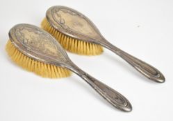 Pair of George V hallmarked silver backed brushes, Birmingham 1919, maker's mark rubbed, length 26.