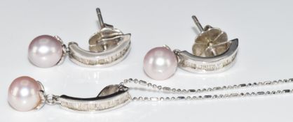 An 18ct white gold pendant set with baguette cut diamonds and a pearl, on 18ct white gold chain,