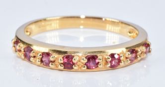 An 18k gold ring set with eight round cut Padparadscha sapphires, with certificate, 3g, size N
