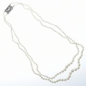 A double strand of cultured pearls with 9ct white gold clasp set with diamonds, 22.6g, 48cm