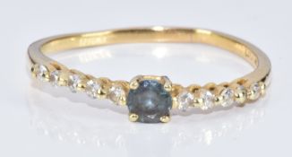 An 18k gold ring set with a round cut natural Alexandrite of approximately 0.27ct and diamonds, with