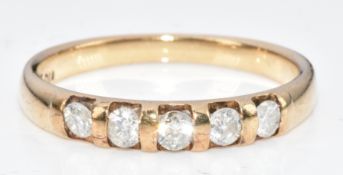 A 9ct gold ring set with five round brilliant cut diamonds totalling approximately 0.3ct, 2.2g, size