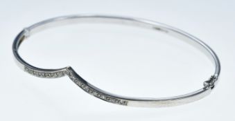 A 9ct white gold bangle set with cubic zirconia, 5.9g