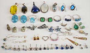 A collection of silver jewellery including four rings set with topaz, sapphires etc, six pendants