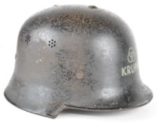 German WW2 era Civil Defence M34 steel helmet with Krupp decal to front and erased double decals