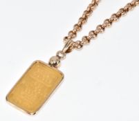 A 9ct gold pendant set with a Credit Suisse 999 fine gold plaque (5g), on 9ct gold chain, 21.4g,