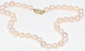 A single strand of cultured pearls with 14k gold clasp set with diamonds, 60.2g, 40cm, pearls