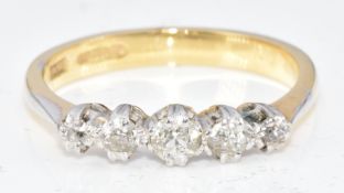 An 18ct gold ring set with five diamonds, 3.1g, size M