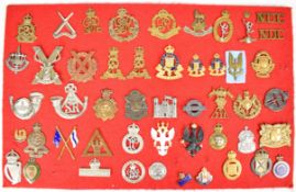 Approximately 50 badges, titles and insignia including 3rd Country of London Yeomanry, Military