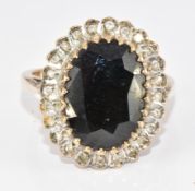 A 9ct gold ring set with a large oval sapphire of approximately 6.2ct surrounded by diamonds. 5.