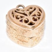 A 9ct gold charm in the form of a heart shaped jewellery box opening to reveal a ring, 5.2g, 1 x 1.