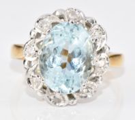 An 18ct gold ring set with an oval cut aquamarine of approximately 3ct surrounded by diamonds, 4.6g,