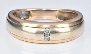 A 9ct bi-coloured gold ring set with two diamonds, 3.1g, size P