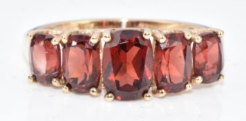 A 9ct gold ring set with five oval garnets, 2.5g, size N